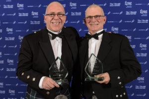 Alex Bain and Ian Donaldson, in kilts, jackets and bow ties, holding their awards